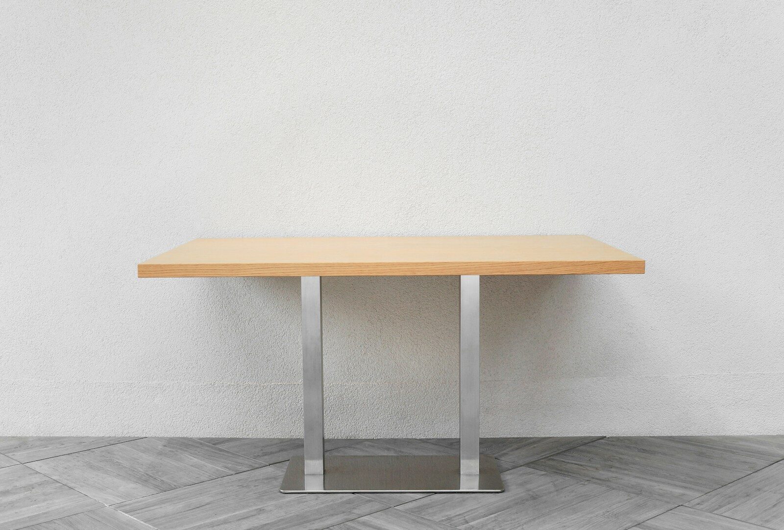 a wooden table sitting on top of a tiled floor